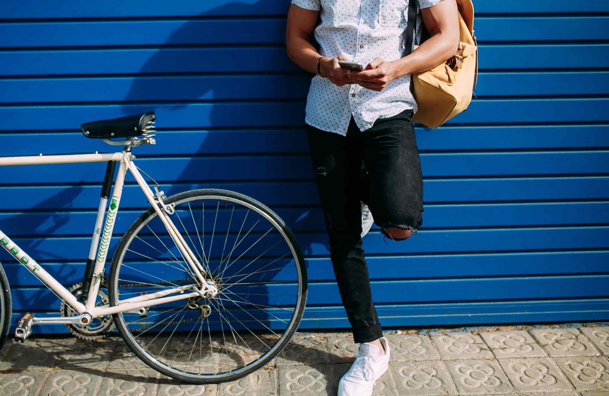 Man Texting Next to Bike