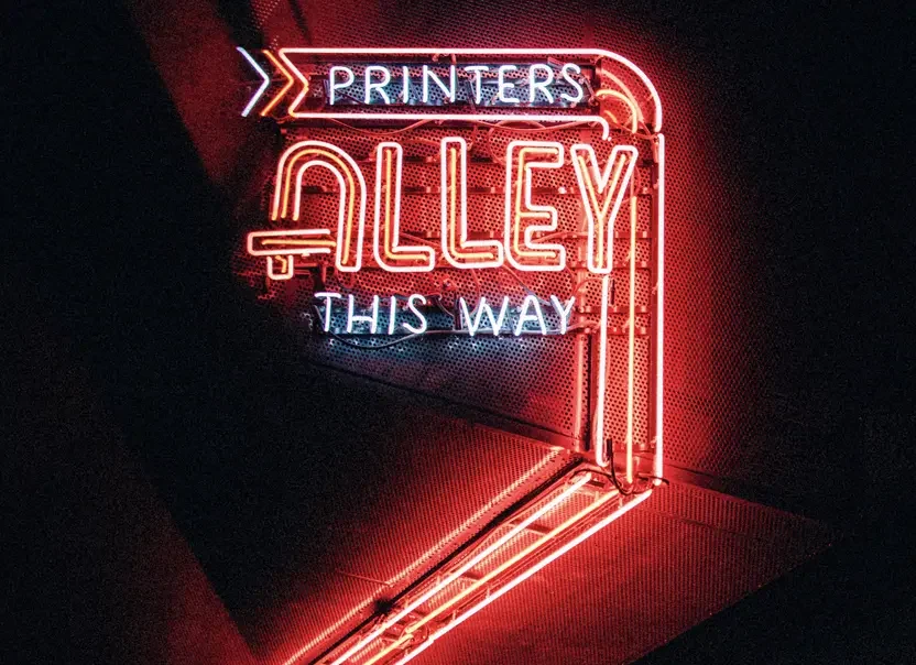 Printers Alley this way lit up neon sign